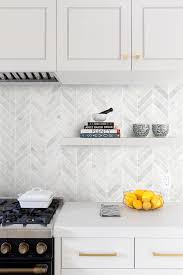 A white backsplash is often used to create a chic and trendy modern farmhouse kitchen, while natural and earthy colors offer a more rustic finish. White Modern Marble Chevron Backsplash Tile Backsplash Com