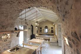 The floors of the rooms were tiled to keep them cool, although in winter fires in metal baskets were sometimes needed. Historical Stone Building In Greece Transformed Into Contemporary Rustic Villa Idesignarch Interior Design Architecture Interior Decorating Emagazine