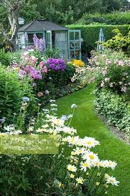 Plant taller flowers towards the rear of your bed. Colourful Back Garden With Mixed Borders Filled With Tender Bedding Plants Shrubs And Perennials Including Leuc Cottage Garden Beautiful Gardens Garden Design