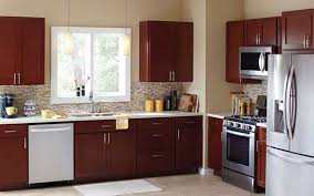A Kitchen With Cabinets In A New Dark Wood Finish Affordable Kitchen Cabinet Low Cost Kitchen Cabinets Affordable Kitchen Cabinets Kitchen Cabinets Home Depot