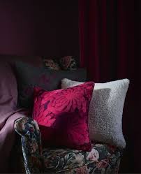Patterned Cushions On A Dark Floral Armchair Against A Dark Red Backdrop Armchair Backdrop Cushions Dark Ikea Christmas Living Room Red Floral Armchair