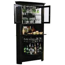 The lower cabinet offers two fixed shelves, while the upper cabinet features an adjustable glass shelf. Corner Bar Cabinet Ideas On Foter