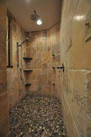 The use of ceramic tile in the shower was widespread through most of the 20th century, but the elegance of natural stone has become prominent in recent decades. 26 Stone Shower Floor Ideas Shower Floor Stone Shower Stone Shower Floor