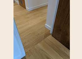 The laying of hardwood flooring on the long side emphasizes the room shape. Floor Transition Ideas Expert Advice Craftedforlife