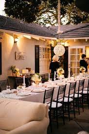 With a beige tablecloth and acrylic chairs, we love how this setting is subtle and understated, allowing the surrounding outdoors to shine. Elegant Fireside Baby Shower The Little Umbrella Backyard Dinner Outdoor Dinner Wedding Dinner