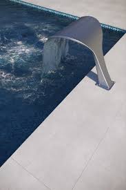 Pool pavers are affordable and are good alternatives to natural stone pool pavers. 2cm Snow White Pool Deck Patio Porcelain Paver Pool Pavers Pool Deck Pavers Poolside Landscaping