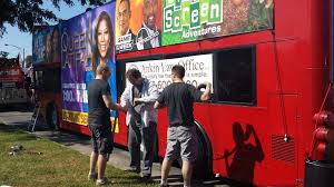 The Ankin Law Office Banner Is Carefully Placed On The Wciu Bus In Preparation For The 84th Annual Bud Billiken Parade Photo Parades Adventure