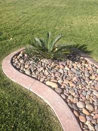 Salt River Rock Cobbles 1 1 2 To 3 Mixed With A Sago A Colored Textured Planterbed Curb Done To High Standards W Rocks For Landscaping River Rock Front Yard