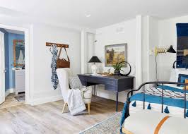 It held a tv and video games, and my husband had set up his desk in one corner. Our Guest Room Office Basement Suite Reveal How To Make A Basement Office Feel Warm Happy And Functional Emily Henderson