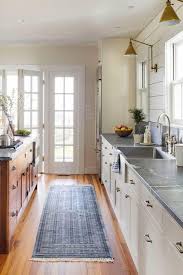 Classic Galley Kitchen Tour This Stunning Waterfront Farmhouse Southernliving In T Farmhouse Style Kitchen Cabinets Cottage Kitchen Cabinets Kitchen Style