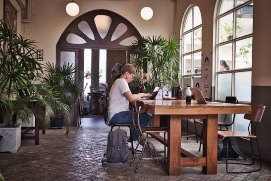 People working from a laptop-friendly cafe