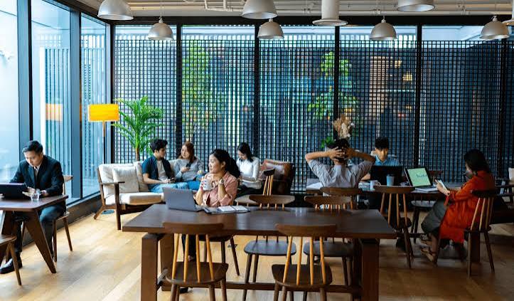People working from a laptop-friendly cafe