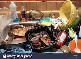 dirty dishes with old food piled in a