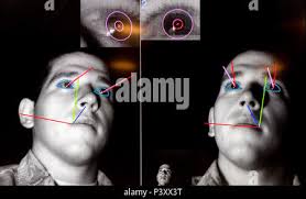 Lt. Michael Emard has the movement of his eyes tracked and blink rate and  pupil dilation measured as he scans a display for data and video feeds. He  is participating in the