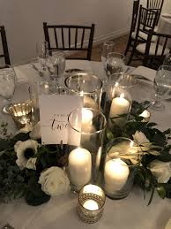 Greenery And Candle Centerpiece Pillar Candle Centerpieces Candle Centerpieces Candle Wedding Centerpieces