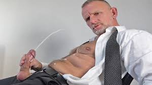 muscle daddy in business suit with big balls and fat cock giving himself a  big load in his own face