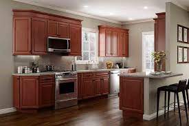 Nowadays, gray is the perfect alternative for whites. The Best Wall Colors To Update Stained Cabinets Rugh Design