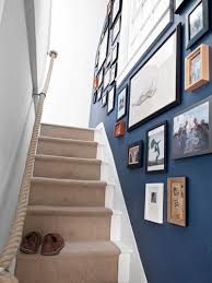 Installing a railing to a narrow staircase will give added security for anyone using stairs. 22 New Ways To Hang Pictures Narrow Staircase Hallway Decorating Stairways