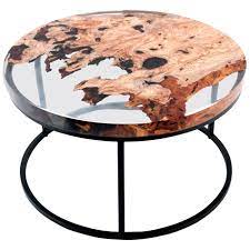 You mix it like cookie dough, mold it like modeling clay and, when it hardens, you carve and sand it just like wood. Round Side Coffee Table Designer Tables And Resin Works