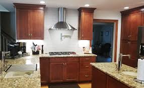 Sebring design build for more modern kitchen designs, choosing two contrasting tones can create a striking color scheme.this kitchen features bright white cabinets with a dramatic charcoal grey stacked stone backsplash. Kitchen Remodeling South Hampton Roads Jerry Harris Remodeling