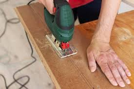 Use a table or circular saw to make long, straight cuts. Premium Photo Installation Laminate Or Parquet In The Room Worker Cuts A Laminate Of A Certain Length With A Saw