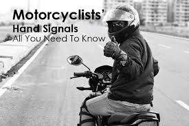 What does it mean when you see a rider coming toward you, tapping the top of their helmet? List Of Motorcyclists Hand Signals Bikesmedia In