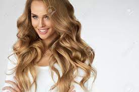 A long bob is a great hairstyle for thick and wavy hair types, as a cut with lots of layers looks like it's full of volume and natural body. Beautiful Curly Hair Smiling Girl With Healthy Wavy Long Blonde Hair Portrait Happy Woman With Beauty Face Sexy Makeup And Perfect Hair Curls Volume Hairstyle Hairdressing Concept High Quality Stock Photo Picture