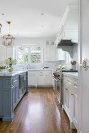 This behr gray color has a blue undertone. White Kitchen With Stacked Cabinets And Grey Island Home Bunch Interior Design Ideas