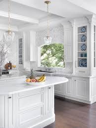 Don't be afraid to use modern materials in a traditional kitchen. Luxury Traditional White Kitchen Crystal Cabinets