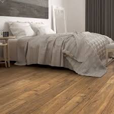 Rooms fit for white floors. Brown Wide Plank Laminate Flooring In A Bedroom Bedroom Laminate Flooring Oak Laminate Flooring Wood Floors Wide Plank