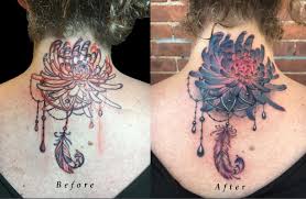 Tattoo to cover up stretch marks maybe! Back Of Neck Lettering Cover Up With Chrysanthemum Flower And Ornamental Feather By Nicole Laabs Tattoonow