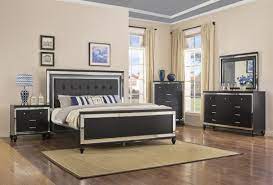 The silver embossed finish and mirror trim give each piece a glitzy look, while led lighting in the upholstered headboard and dresser mirror. Valentino Black Four Piece Bedroom Set