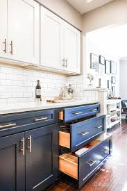 Classic Kitchen With Navy And White Cabinets White Subway And Wood Flooring White Kitchen Design Kitchen Cabinets Color Combination Kitchen Design