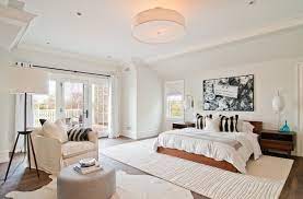 Check out the small primary bedroom with dark wood flooring above. Winning Combination Wood And White In The Bedroom