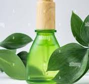 skin care serum in green glass bottle with dropper on white ...