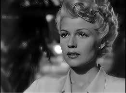 Rita Hayworth. For those that may question this, Rita bleached her hair  blonde when she appeared in the 1947 film The Lady From Shanghai. Beautiful  coat/gown but those sandals! are something else.