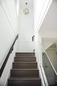 Wall rails are an excellent choice for interior stairways where balusters aren't necessary. Glass Staircase Railing With Gray Wash Stair Treads Modern Entrance Foyer