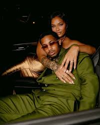 Streamers @ddg and @lovelyseven made quite the entrance at Streamer  University Prom. The new couple stepped out in coordinating statement  looks, with DDG wearing an olive-green double-breasted suit, layered chains  and red-tinted