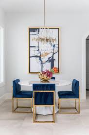 Luxe Dining Space Boasts Contemporary Furnishings A Set Of Gold And Sapphire Blue Velvet Dining Chairs Fr Gold Dining Room Dining Room Blue Luxury Dining Room
