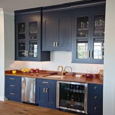 Though this designer opted for white cabinets on most of the kitchen, adding a deep gray pantry is a great way to add dimension to the space. Navy Wet Bar Cabinets With Wood Countertops And Stainless Steel Mini Fridge Transitional Kitchen Benjamin Moore Hale Navy