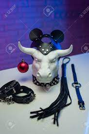 White Metal Bull Figurine With A New Years Toy In A Leather Mask And  Accessories For BDSM Games Stock Photo, Picture and Royalty Free Image.  Image 161111968.