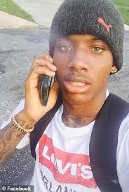 Family of armed black man, 22, who was shot in the back by plainclothes  police to file lawsuit