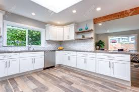 Gray quartz countertops are coming right behind the white ones in terms of popularity these days. Open Concept Kitchen With White Cabinets Grey Quartz Countertops Stock Photo Picture And Royalty Free Image Image 104976948