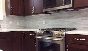 Our remodeled kitchen featuring delgatie matte™ countertops and custom mosaic tile backsplash. Beautiful Cherry Cabinets In Remodeled Kitchen With White Tile Backsplash And White Quartz Counte Cherry Cabinets Kitchen Kitchen Remodel Kitchen Remodel Plans
