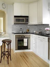 Suzie Margot Austin Small L Shaped Kitchen With White Kitchen Cabinets With Granite Countertops Kitchen Kitchen Cabinets Black Countertops