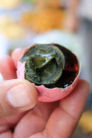 Its main raw material can be duck or chicken eggs. Eating A Preserved Century Egg At A Thai Market