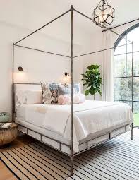 Whether a wood canopy, metal, or modern bed, there's a timeless, almost royal nature to them. Metal Canopy Bed With Pink And Blue Pillows Transitional Bedroom Metal Canopy Bed Home Bedroom Transitional Bedroom