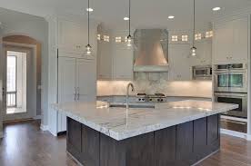 A glass backsplash provides a stunning shine. Corner Kitchen Ideas Transitional Kitchen Gonyea Homes
