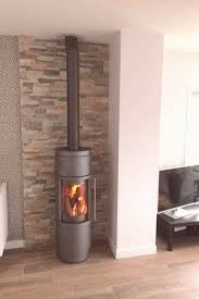 poele hase sila gris et mur en parement pierre naturelle en 2020 poele a bois poele a bois en coin mur en pierre salon