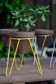Tall black powder coat metal small indoor/outdoor patio flowerpot plant stand Modern In Design And Small In Size This Yellow Steel Tripod Plant Stand Is Perfect For Small Plants And Modern Plant Stand Metal Plant Stand Iron Plant Stand